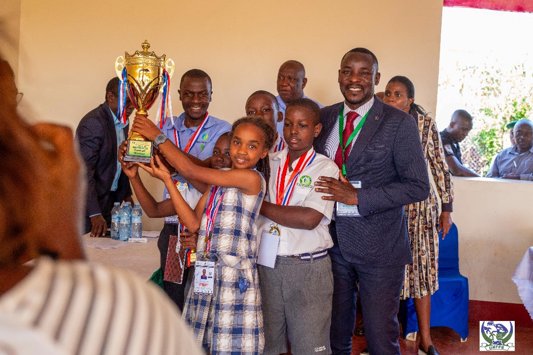 Pupils holding a winner's trophy